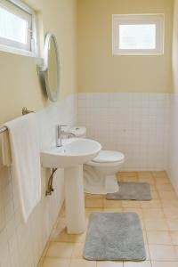 a bathroom with a sink and a toilet at Lotus Mountain Retreat in Kandy