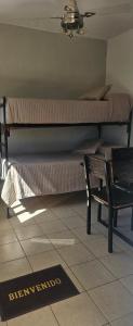 a room with two bunk beds and a bench at La NIÑA 6 in Jesús María