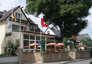 ein Restaurant mit einer kanadischen Flagge davor in der Unterkunft Lindenhof in Osterspai