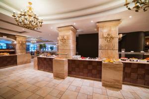 a hotel lobby with a buffet line with food at Maritim Antonine Hotel & Spa in Mellieħa