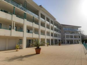 a large white building with a large courtyard at Appartement à Ciboure avec piscine chauffée et parking privé - FR-1-239-560 in Ciboure