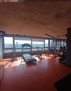 a gym with several treadmills and exercise bikes at Santa Rosa del Mar, Departamento in Coquimbo