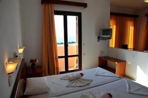 Posteľ alebo postele v izbe v ubytovaní Kyma Hotel