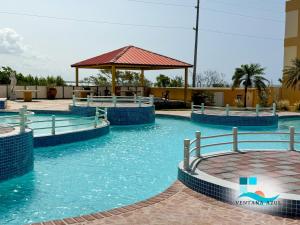 a swimming pool at a resort with a gazebo at Condo Ocean View from Balcony Swimming Pool Playa Sucia in Cabo Rojo