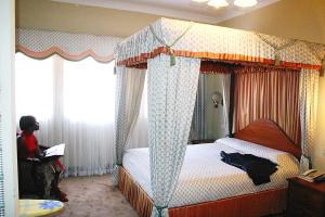 Postel nebo postele na pokoji v ubytování Grand Imperial Hotel