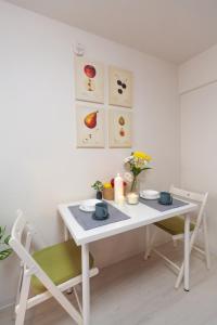 a white table and chairs in a room at Home Tokyo Takinogawa in Tokyo