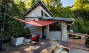 a house with a red hammock on a deck at La Verrière du Lac in Sévrier