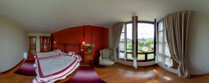 Un dormitorio con una cama y una ventana grande. en La Casona de la Roza, en Valbucar