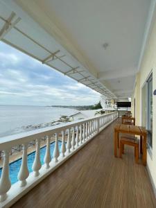 a balcony with a table and a view of the ocean at Nadelmar Hotel and Resort in Dalaguete