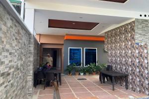 a person sitting at a table in a building at White-Beach Hideaway Resort Puerto Galera in Puerto Galera