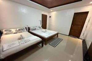 a bedroom with a bed and a coffee table at White-Beach Hideaway Resort Puerto Galera in Puerto Galera