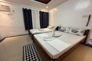 Postel nebo postele na pokoji v ubytování White-Beach Hideaway Resort Puerto Galera