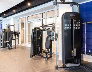 a gym with several treadmills and machines at North End 2BR Condo w Pool & Gym in Boston