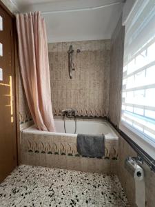 a bathroom with a bath tub with a shower at Casa Chao in Estopiñán