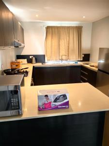 a box on a kitchen counter with a microwave at Pacific FairPrice Private room in Nadi +10 photos