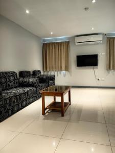 a living room with a couch and a table at Pacific FairPrice Private room in Nadi