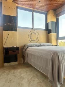 a bedroom with a bed and two windows at Condominio Agave del Mar in Coyuca +91 photos