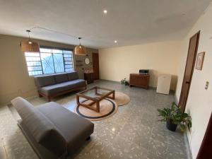 a living room with a couch and a coffee table at Mola Mola Rooms in Mérida