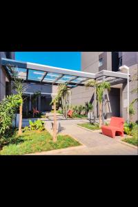 a large building with a red bench and palm trees at MV 135A Studio 135, com AR Condicionado a 50 mts do METRÔ Brás Rua Coronel Mursa, 56 in Sao Paulo +44 photos