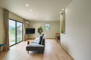 a living room with a couch and a table at Green Peak 1 in Aso