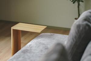 a close up of a wooden table next to a couch at Green Peak 1 in Aso +42 photos