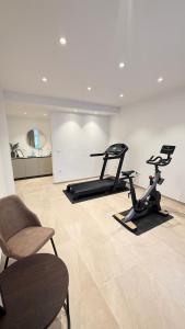 a gym with two exercise bikes and two chairs at Villa Mirko in Barbariga