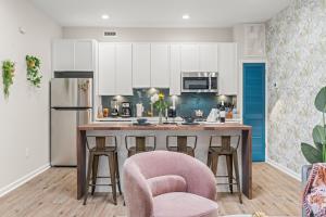 a kitchen with a pink chair and a kitchen island at Historic Old City 1BR 1BA Near Independence Hall in Philadelphia