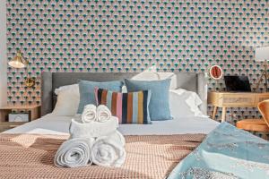 a bedroom with a bed with towels on it at Historic Old City 1BR 1BA Near Independence Hall in Philadelphia