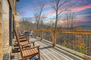 a deck with chairs and a view of the mountains at Wild Heart Lodge cabin in Sevierville