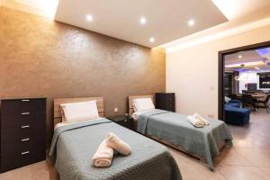two beds in a hotel room with towels on them at Luxury Apartment in Gzira close to Sliema 3 BR Apartment Sleep 8 in Il-Gżira