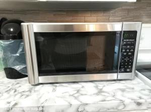 a microwave oven sitting on top of a counter at Executive Private Room in a Shared Apartment- Comfortable and Convenient in Saint John
