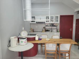 a kitchen with a wooden table and some chairs at Redhome Dorm 2 in Thủ Ðức