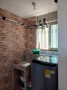 a room with a heater and a brick wall at Acogedor apartamento en ibague 403 in Ibagué