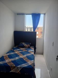 a bedroom with a bed and a large window at Acogedor apartamento en ibague 403 in Ibagué +9 photos