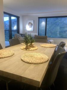 a dining room table with a christmas tree on it at Modern Luxury Condo Shotover Views in Queenstown +8 photos