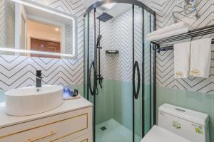 a bathroom with a sink and a shower at 云深处江景公寓 in Chongqing