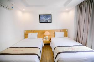 Giường trong phòng chung tại Nhat Linh Hotel & Suites Da Nang