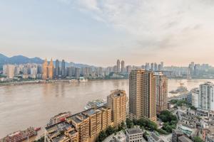 a view of a city with a river and buildings at 云深处江景公寓 in Chongqing