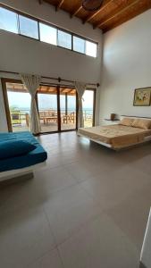 a bedroom with two beds and a view of the ocean at Rapallo Punta Sal in Canoas de Punta Sal +42 photos