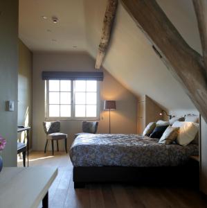 Ένα ή περισσότερα κρεβάτια σε δωμάτιο στο B&B Het Rooj