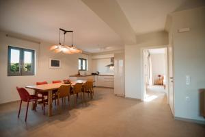 a dining room and kitchen with a table and chairs at Citrus & Fig Villas Your Hidden Paradise in Panormos Rethymno