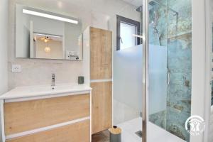 a bathroom with a sink and a shower at La source in Plouhinec +28 photos