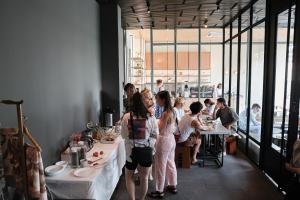 a group of people sitting at tables in a restaurant at Once Again Hostel in Bangkok