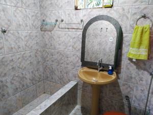 a bathroom with a sink and a shower with a mirror at Espaço Sinara in Jaraguá