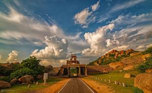 a road leading to a building on a hill at HAREKRISHNA GUESTHOUSE HAMPi in Hampi