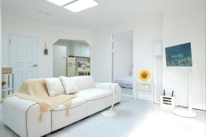 a white living room with a white couch at busan in peum in Busan