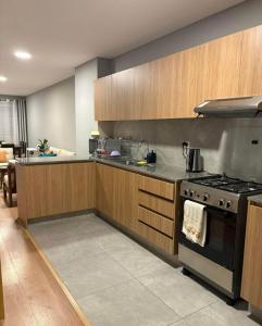 a kitchen with a stove and a sink at inti apart center in Cusco