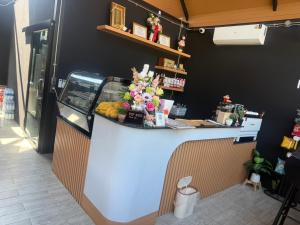 a counter in a store with a fruit display at Oh my cup khao sok resort in Khao Sok National Park