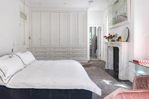 a white bedroom with a bed and a fireplace at The Darling Private Oasis with Heated Magnesium Pool in Sydney +36 photos