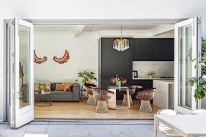a kitchen and living room with a table and chairs at The Darling Private Oasis with Heated Magnesium Pool in Sydney